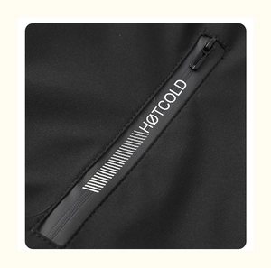 Macro detail of waterproof zipper with white HØTCOLD print on black athletic jacket