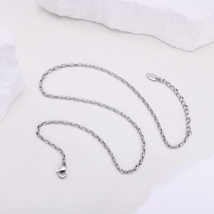Detail of silver box chain necklace featuring a lobster clasp and K18 hallmark tag