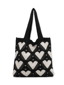 Chic knitted tote bag with white heart patterns and silver rivet accents on black fabric