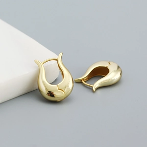 Detailed view of U-shaped gold earrings with polished finish and secure snap closure