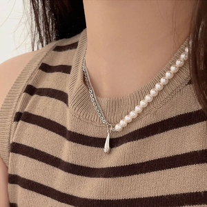 Asymmetric 925 sterling silver pearl necklace with elegant water drop pendant on a model
