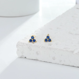 Close-up of S925 silver stud earrings with three blue zircon stones in a triangle