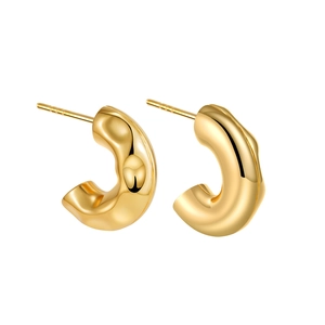Detailed view of golden C-shaped hoop earrings with hammered metal texture and wavy design