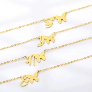 Minimalist gold butterfly necklaces set with artistic letter pendants on white background