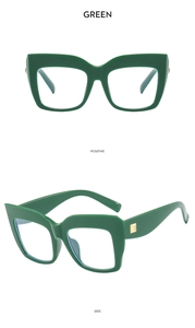 Detail view of dark green cat eye glasses with gold metal accents and thick frame