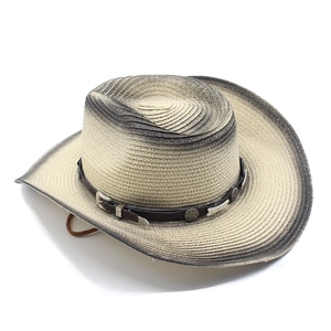 Detail of woven straw texture and vintage leather band with star rivets on cowboy hat