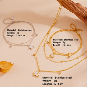 Gold and silver butterfly jewelry set in stainless steel with crystal accents on wood