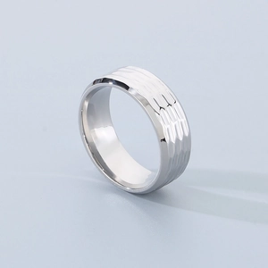 Macro shot of polished silver titanium steel ring with unique hammered metal texture