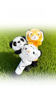 Detail of plush animal finger puppets including panda and tiger on green grass