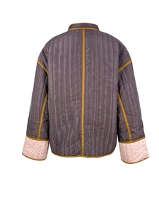 Rear view of color-block quilted jacket with ochre trim and pink contrast cuffs