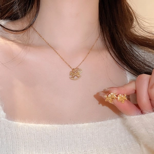 Close-up of model wearing gold-plated rocking horse jewelry set with sparkling crystals