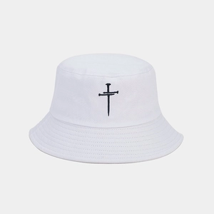 Close-up of black cross embroidery detail on white cotton bucket sun hat
