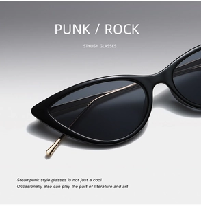 Detail of stylish cat-eye sunglasses with sleek black frame and golden temple accents
