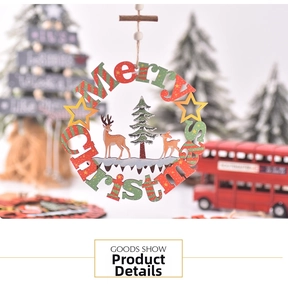 Detail of laser-cut wooden Merry Christmas ornament with reindeer and cedar tree