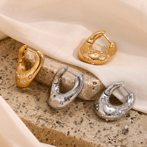 Irregular twisted U-shaped 18K gold and silver earrings with sparkling rhinestones