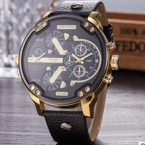 Detail of men's large black multi-dial watch with gold steel case and leather strap