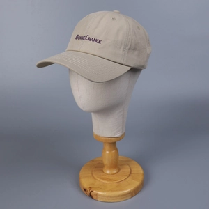 Detail of purple Bonne Chance embroidery on breathable khaki cotton baseball cap