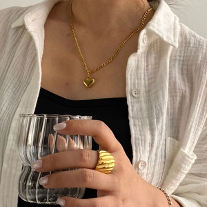 Gold-plated stainless steel layered heart necklace and ripple ring worn on model