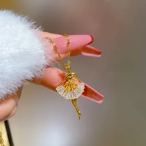 Detailed macro view of gold ballet girl pendant with layered zircon stones and shimmering crystals