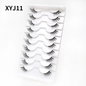 Close-up of 10 pairs of natural criss-cross cat eye false eyelashes in a white tray