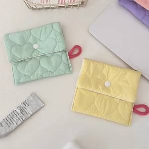 Quilted heart pattern pouches in mint green and light yellow with a secure button closure