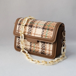 Plaid flap bag with chunky marble resin chain and brown leather trim in 45-degree view