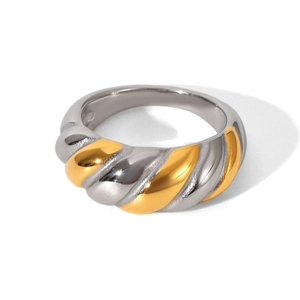 Macro detail of two-tone croissant ring showing gold and silver twisted metal texture