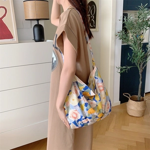 Floral canvas tote bag shown on shoulder in a minimalist and modern home interior