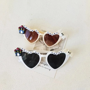 Kids heart sunglasses with Trick or Treat letters in white and beige colors