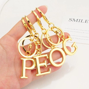 Polished gold initial keychains with P E O G letters and durable spring clasps