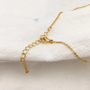 Macro shot of gold lobster clasp and extension chain on the baroque pearl necklace