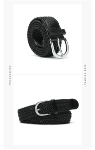Close-up of black braided belt with silver metal pin buckle and leather reinforced tip