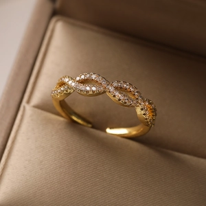 Elegant gold plated open ring with pavé cubic zirconia on a brown jewelry box