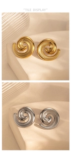 Detailed view of spiral texture on gold and silver starfish earrings on stone base