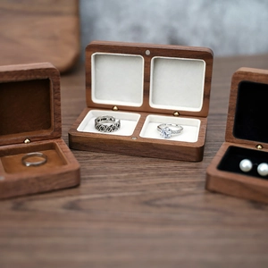Detail of walnut wood jewelry box with soft velvet lining and magnetic closure mechanism