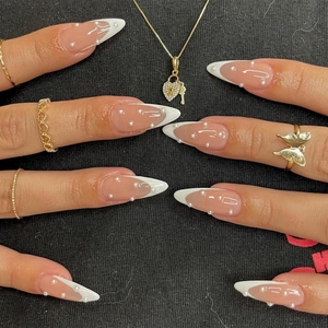 French style long pointed press-on nails in nude pink with white tips and pearl accents