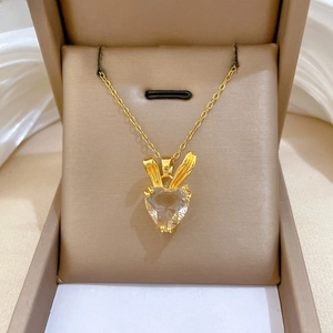 Close-up of golden bunny heart pendant with zircon in a premium jewelry box