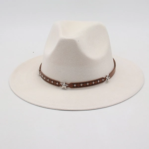 Close-up of beige fedora hat featuring brown leather band with silver star studs