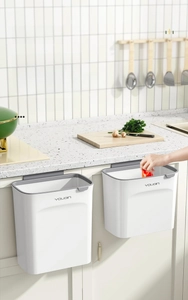 Dual wall-mounted kitchen trash cans in white and grey for easy waste disposal