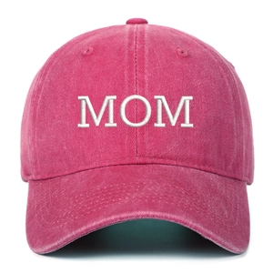 Close-up of MOM embroidery on pink washed cotton baseball cap with fabric texture details