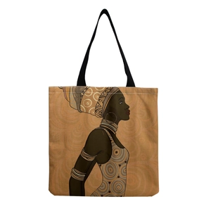 Detailed view of the reusable canvas tote bag featuring an artistic African woman portrait