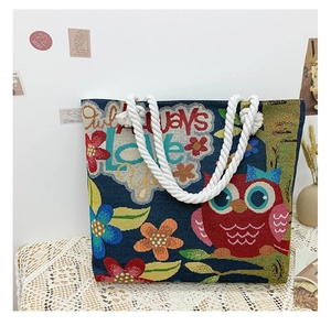 Detail of jacquard tote bag with owl floral pattern and cotton rope handle