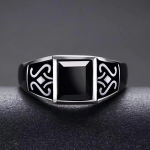 Detailed close-up of a men's vintage totem ring with black obsidian stone inlay