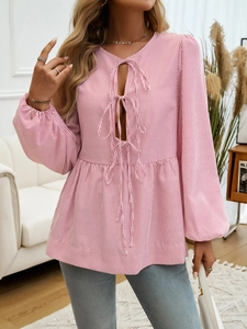 Pink and white striped blouse detail with lantern sleeves and three front tie closures