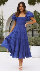 Close-up of royal blue tiered dress with smocked bodice and puff sleeves detail