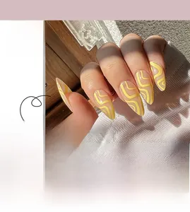 Detail of yellow abstract wave long stiletto press-on nails shown on hands and loose