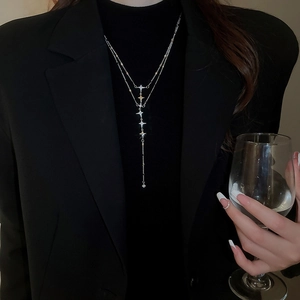 Close-up of double layer stainless steel necklace with sparkling star pendant on a model
