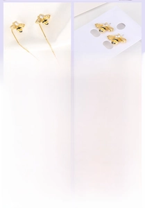 Detailed macro view of 18K gold plated bee pendant earrings with tassel chains