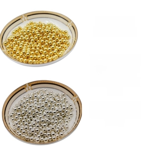 Macro shot of 14k gold-filled and silver-plated smooth metal spacer beads for DIY jewelry