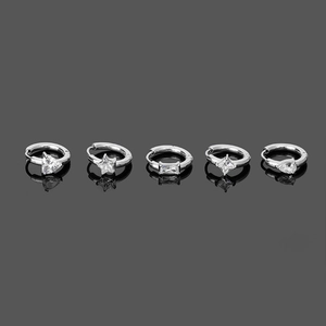 Detail of silver hoop earrings featuring heart, star, and drop shaped zircons